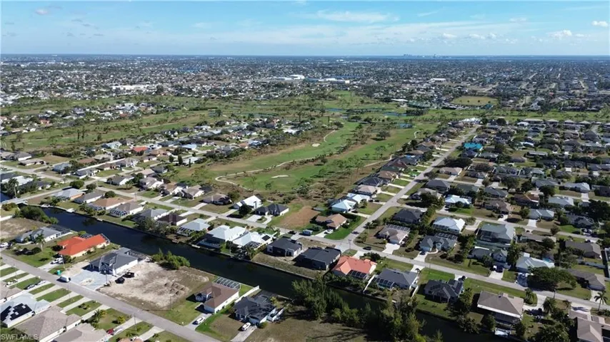 Aerial overview of property's location featuring nearby suburban area and a large body of water