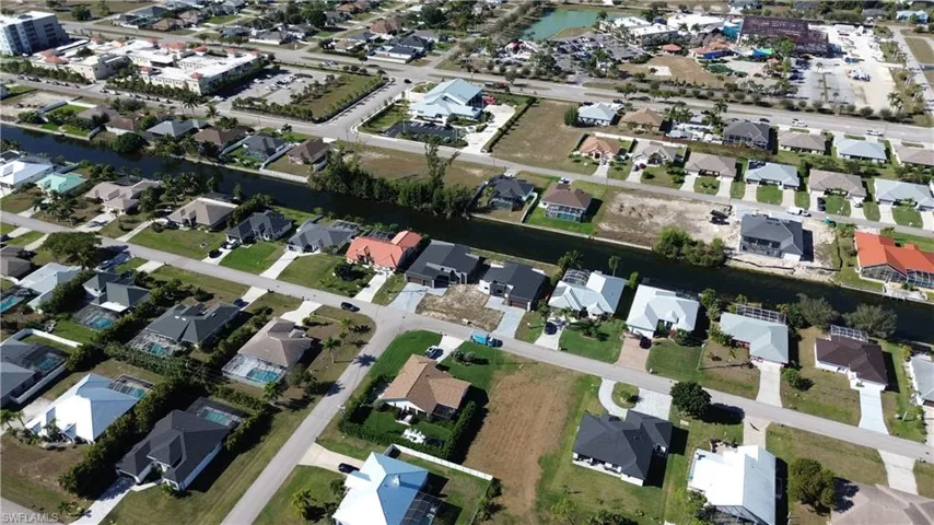 Aerial overview of property's location with nearby suburban area and a nearby body of water