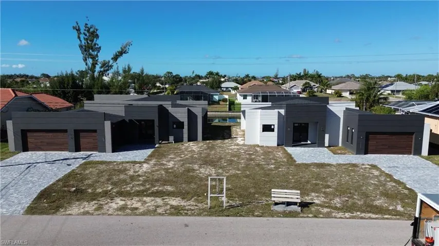 Contemporary home featuring a residential view, an attached garage, and decorative driveway
