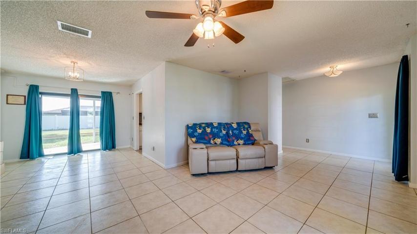 Living area home tiled throughout LVT in kitchen