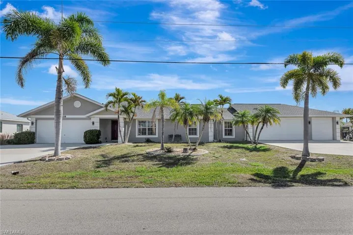 Single story home with an attached garage, driveway, and a front yard