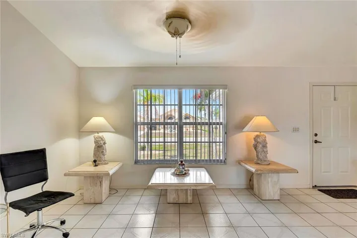 Sitting room with baseboards and light tile patterned floors