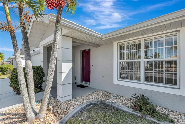 View of exterior entry with stucco siding