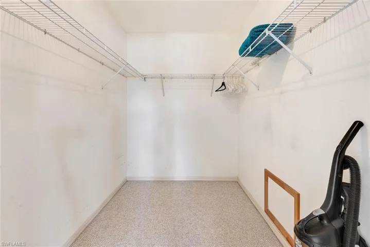Walk in closet featuring light carpet