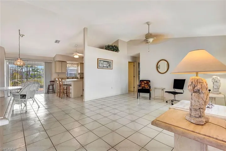 Living room featuring vaulted ceiling and a ceiling fan