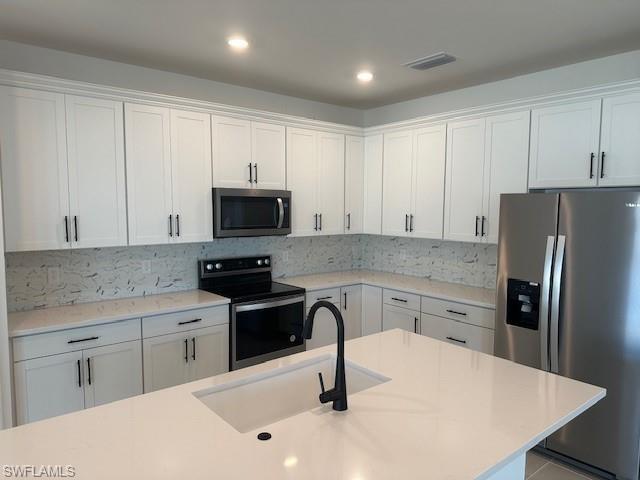 Kitchen island - quartz countertops & stylish backsplash