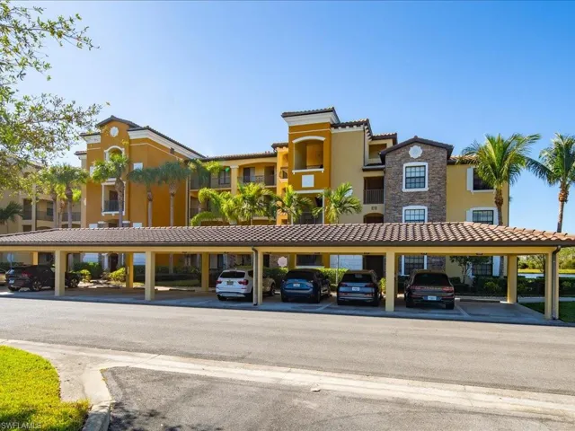 View of property with covered parking