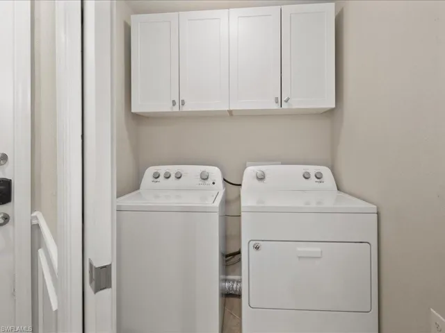 Laundry room with cabinet space and washing machine and clothes dryer