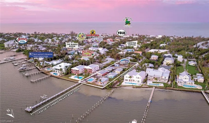Aerial view at dusk featuring a water view