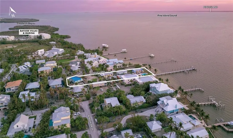 Aerial view at dusk featuring a water view