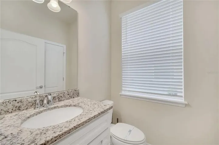 Half bathroom with vanity and toilet