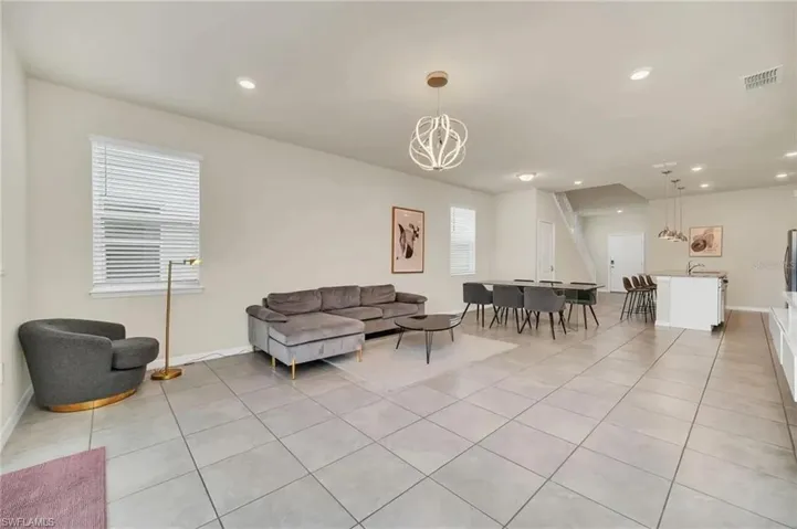Living area featuring light tile patterned flooring and recessed lighting