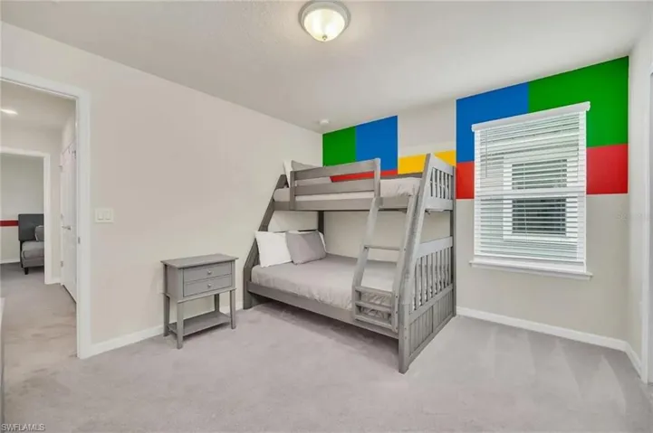 Bedroom featuring light carpet