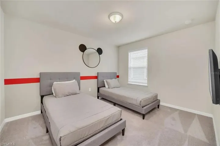 Bedroom featuring carpet flooring and baseboards