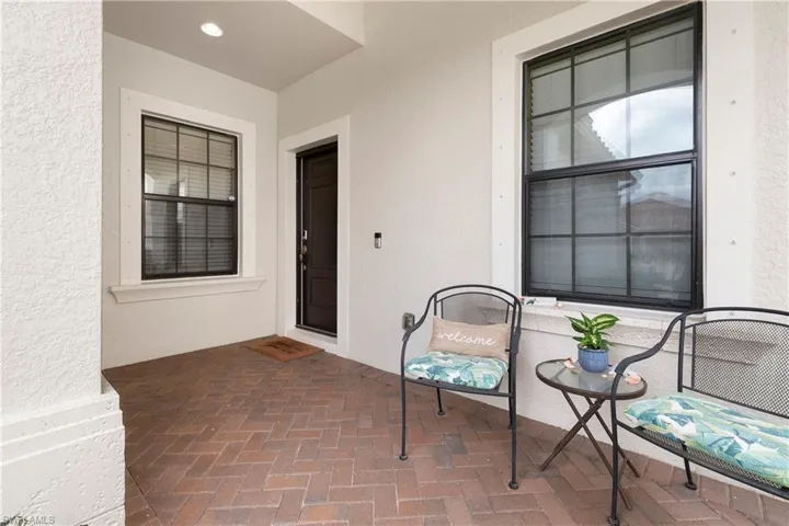 Entrance to property with stucco siding