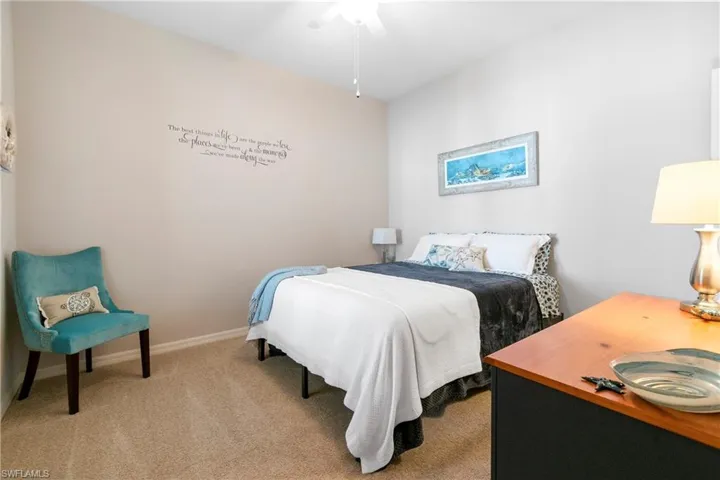 Bedroom featuring light carpet and baseboards
