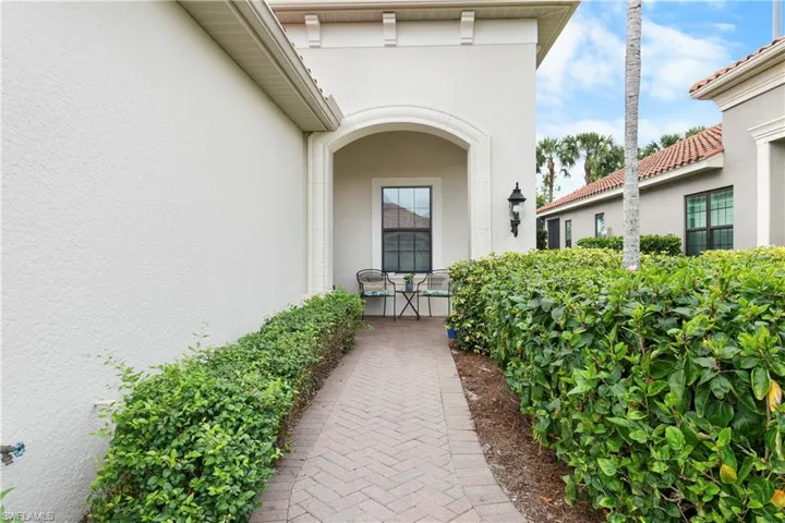 View of exterior entry featuring a tile roof and stucco siding