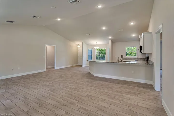 Wood look tiled floors, Recessed LED Lighting, 5 1\4" baseboards
