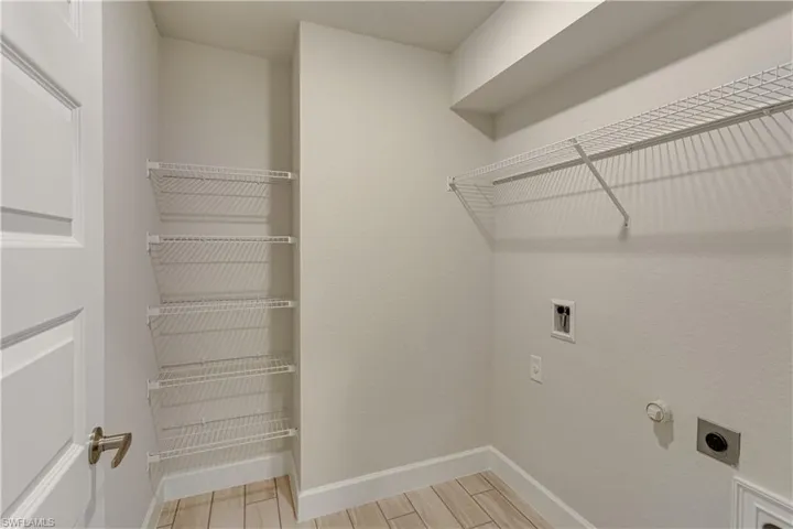 Washroom featuring laundry area, baseboards, hookup for an electric dryer, washer hookup, and hookup for an electric dryer