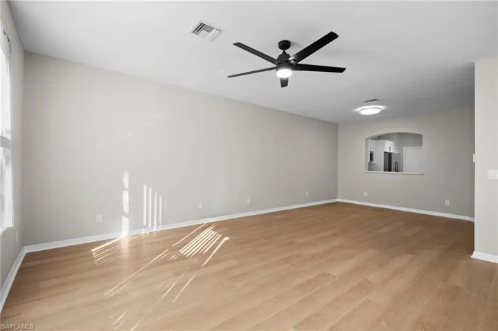 Spare room featuring light wood finished floors and a ceiling fan
