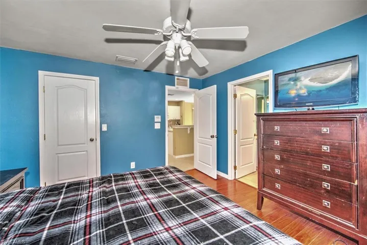 Bedroom with hardwood / wood-style flooring and ceiling fan