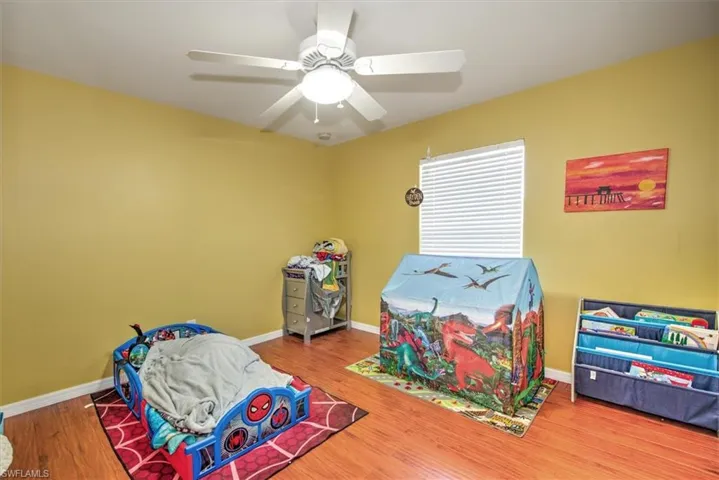 Rec room with hardwood / wood-style floors and ceiling fan