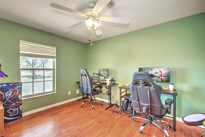 Office with wood-type flooring and ceiling fan