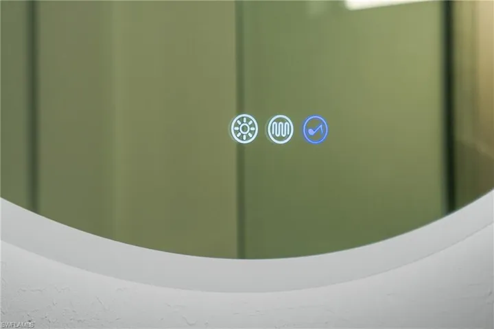 Round vanity mirror with integrated backlighting, defogger, and Bluetooth speaker controls