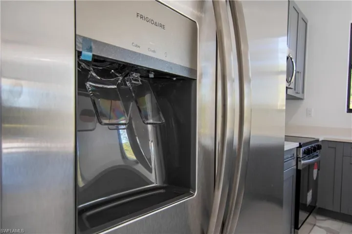 Stainless steel refrigerator with a built-in ice and water dispenser