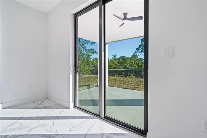 Sliding glass doors opening to the exterior patio