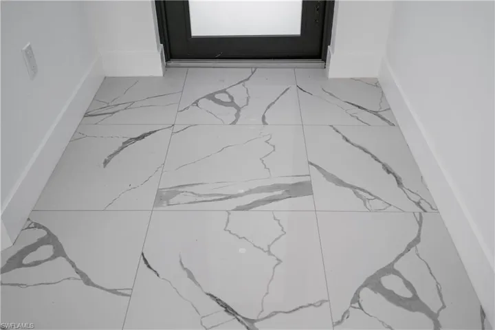 Large format porcelain tile flooring with grey veining