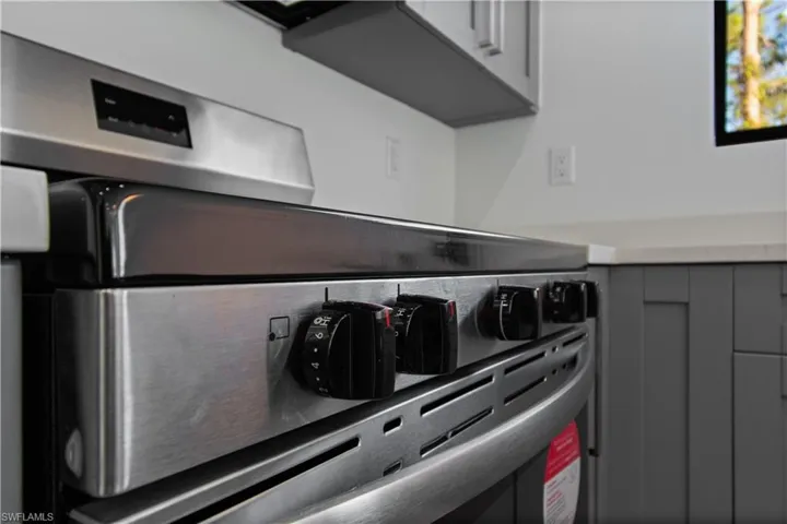 Stainless steel range featuring control knobs and a digital display