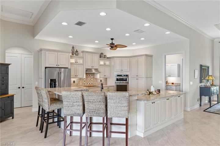 Custom cabinets with pull outs, built ins, and a wonderful large area that easily holds 6 seat or more around the island!