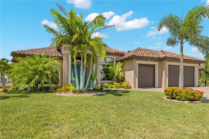 CURB APPEAL ALERT!  Regal royal palms line the front of the home along with lush landscaping beds, beautiful pavers and outdoor lighting!