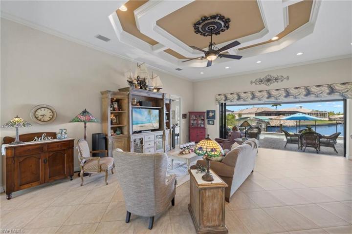 As soon as you walk through the double doors, this incredible view to the outdoors takes your breath away!  Large greatroom with soaring 12 and 14 ft ceilings.