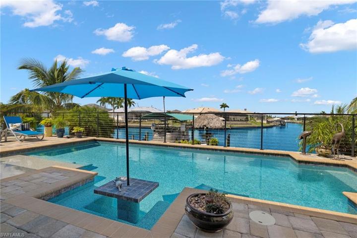 Welcome to paradise!!!  Intersecting canal views from every direction!  INCREDIBLE outdoor entertainment area!  This is what SWFL living is all about!