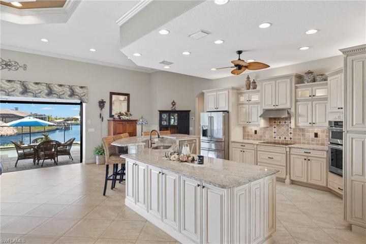 TONS of storage space, even on the front of the island - all high end and a work of art!  Look at the beautiful view of the water from the kitchen!!!!