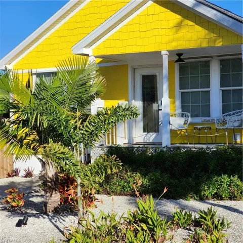 Vibrant yellow exterior featuring shingle siding and white trim