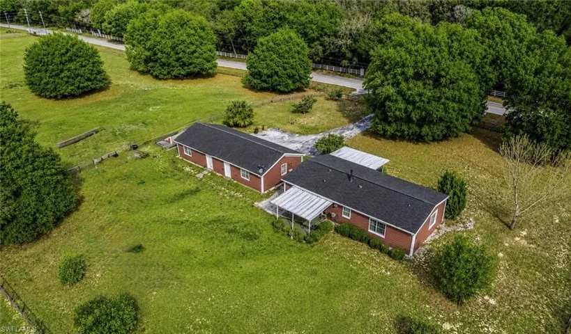 Red-sided property with black shingle roofing