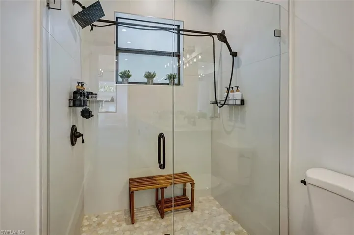 Bathroom with tile patterned flooring, toilet, and walk in shower