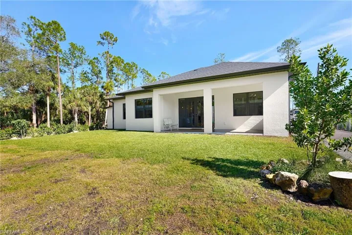 Back of house featuring a patio area and a yard