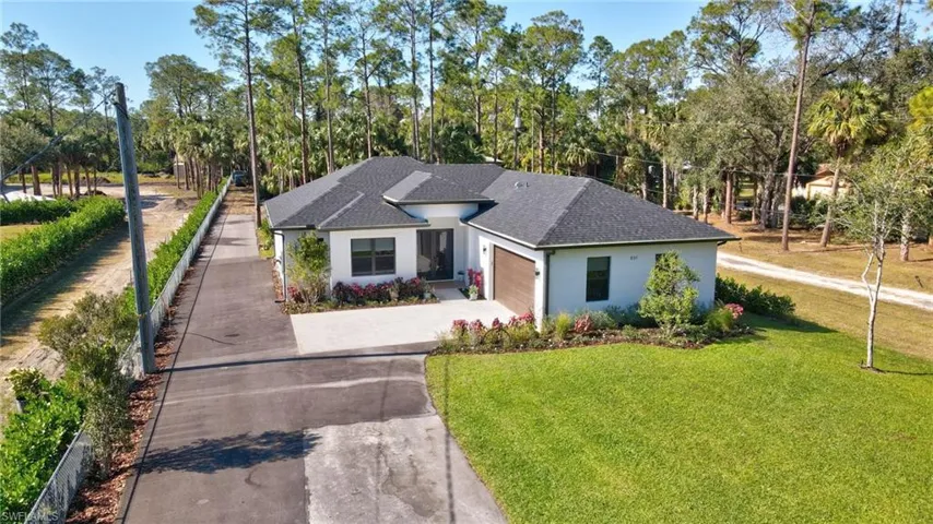 View of front of home featuring a front yard and a garage