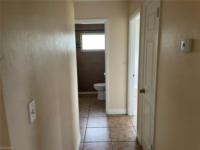 Hall with light tile patterned floors