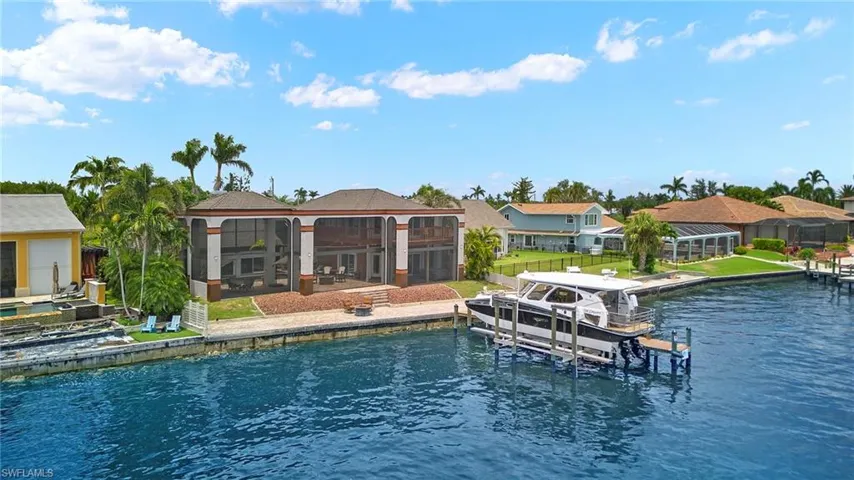 View of exterior lanai featuring a boat dock, a water view, and huge captains deck