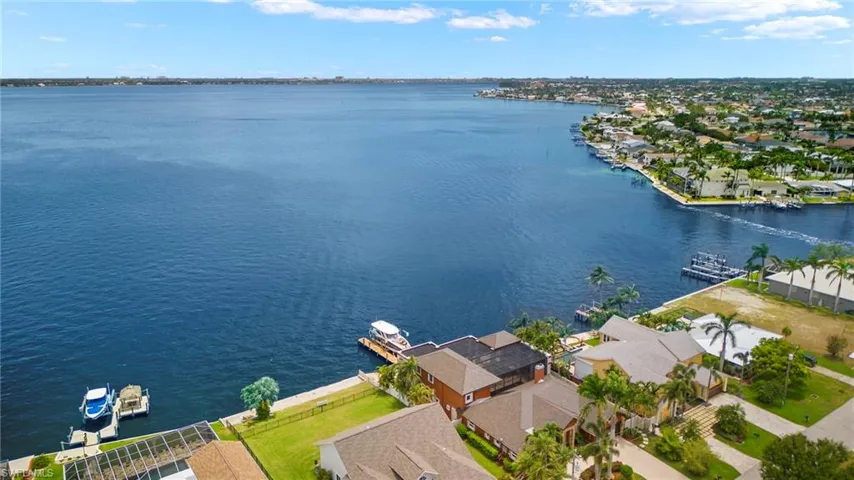 Birds eye view of property with a water view