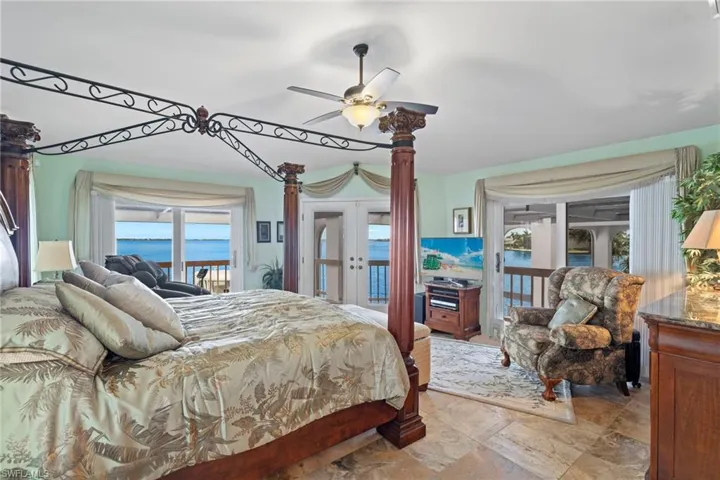 Bedroom with access to exterior, french doors, and ceiling fan