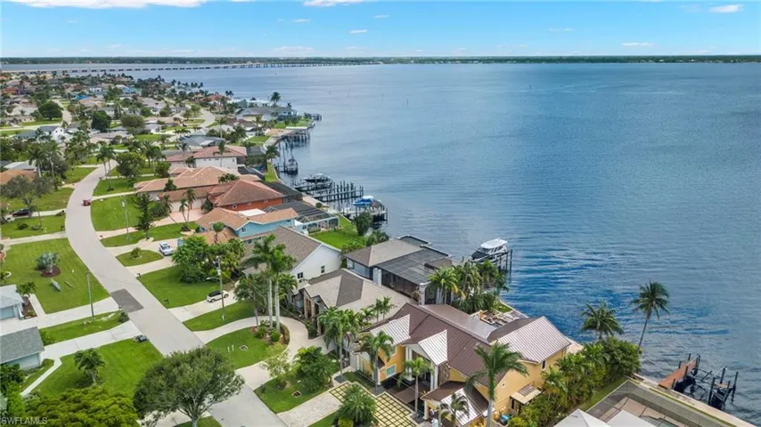 Birds eye view of property with a water view