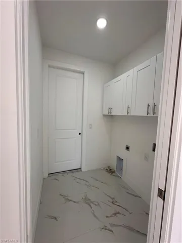 Laundry area featuring cabinets and hookup for an electric dryer