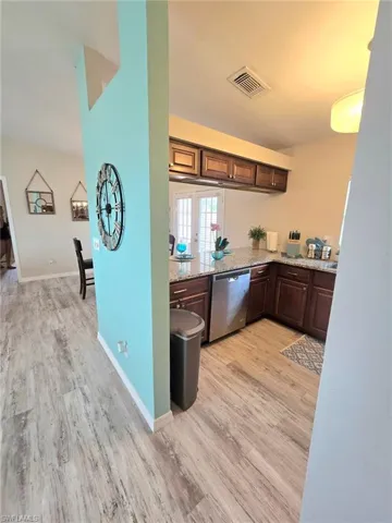 Accent wall dividing Kitchen Living Room.  Kitchen featuring open bar area with plenty of cabinets for extra storage