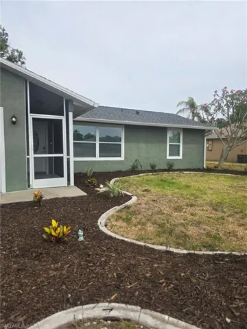 Curbed and recently mulched with automatic sprinkler